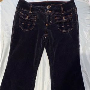 Black corduroys with orange stitching